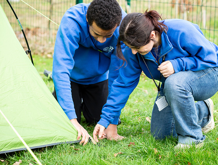 Public service students putting up tents