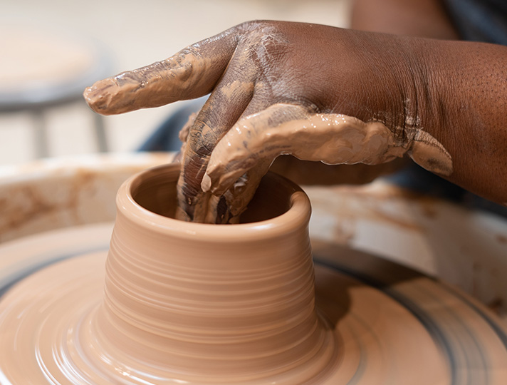 Hands using the wheel in the ceramics studio