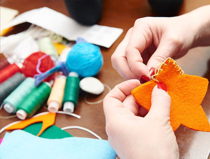 Hands sewing a star 