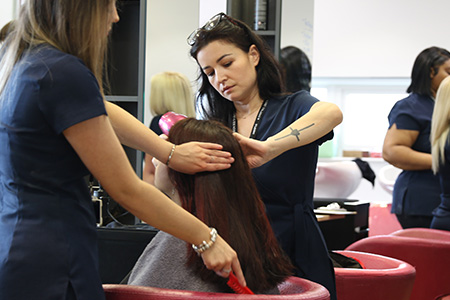 Student participating in styling hair 